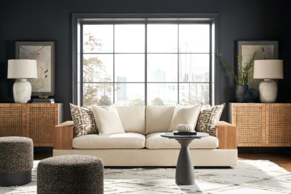 Modern living room with beige sofa and window view.