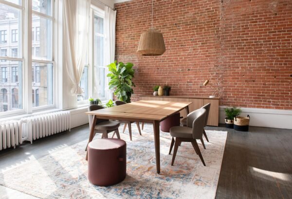 Modern dining area with brick wall and plants.