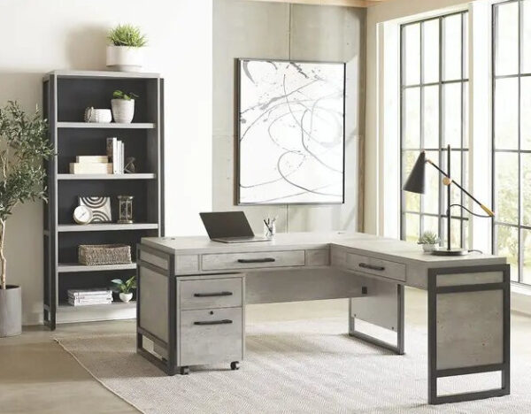 Modern office desk with laptop and bookshelf