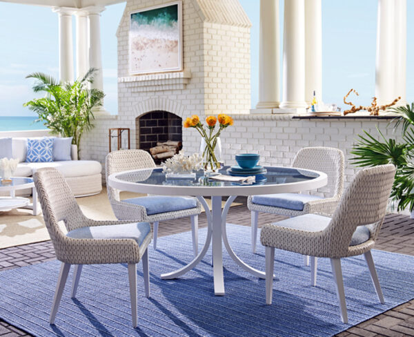 Outdoor patio with table, chairs, ocean view.