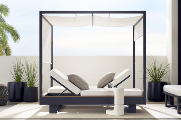 Modern outdoor daybed with canopy on a patio.