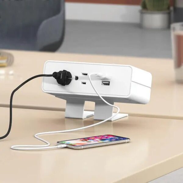 Desk power outlet charging smartphone