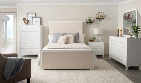 Cozy bedroom with modern white furniture and decor.