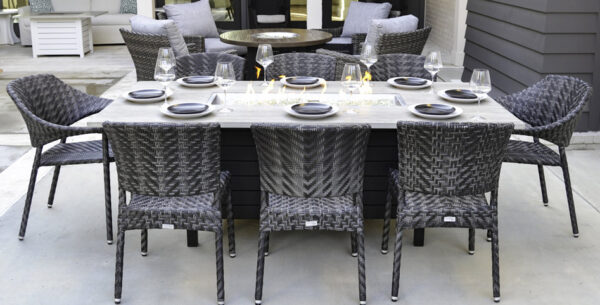 Outdoor dining set with wicker chairs and table.