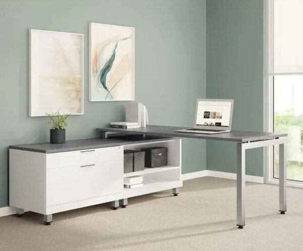 Modern office desk with computer and decor.