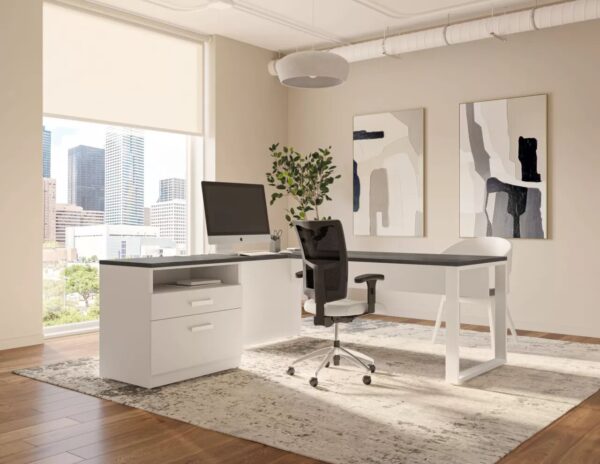 Modern office with desk, chair, computer, and artwork.