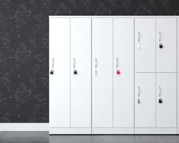 White lockers with padlocks against dark wall