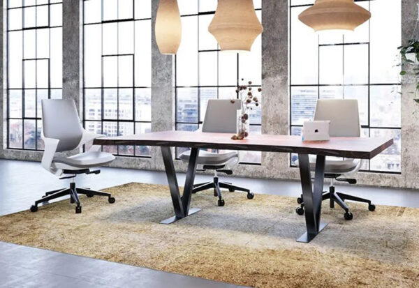 Modern office with table and swivel chairs.