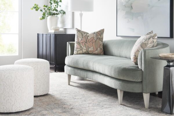 Elegant living room with green sofa and cushions.