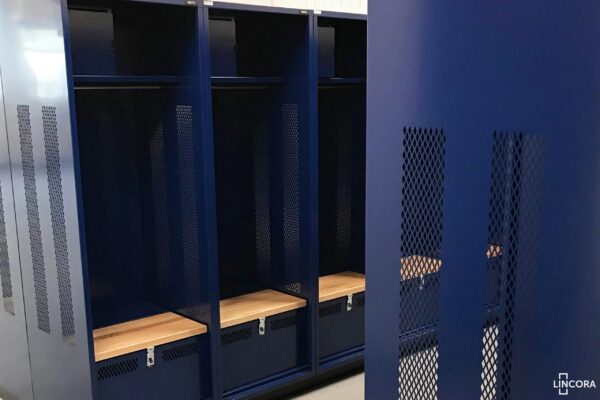 Blue metal lockers in a gym locker room.