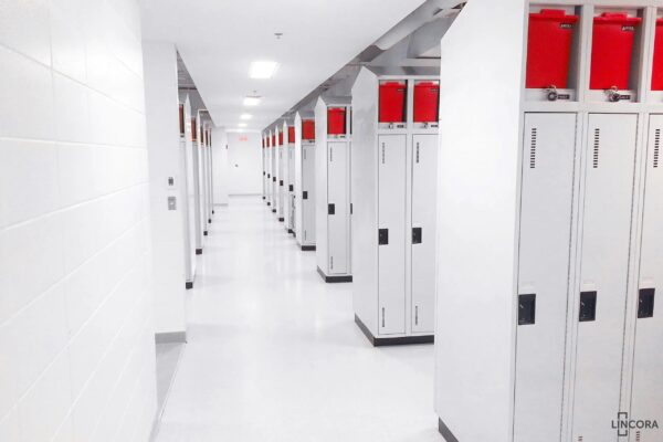 White hallway with rows of storage lockers