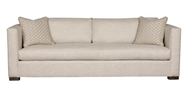 Beige sofa with patterned cushions, front view.