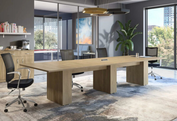 Modern conference room with large wooden table.