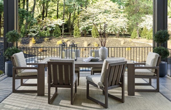 Outdoor patio with table and chairs, garden view.