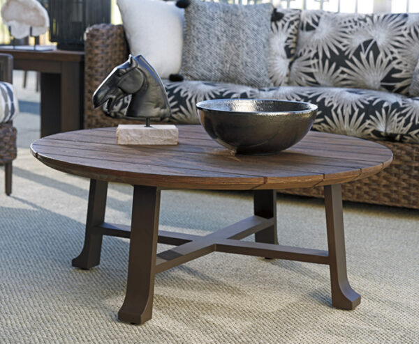 Wooden coffee table with decorative bowl and sculpture.