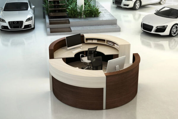 Modern showroom with circular reception desk and cars.