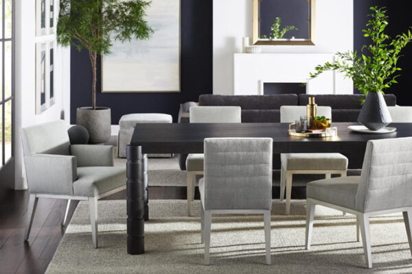 Modern dining room with plants and dark table.