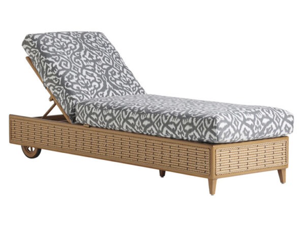 Rattan chaise lounge with patterned cushions.