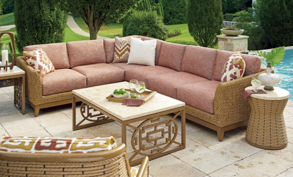 Outdoor patio set near pool with greenery.