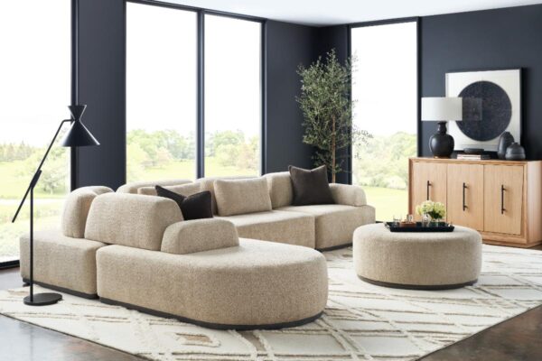 Modern living room with beige couch and decor.