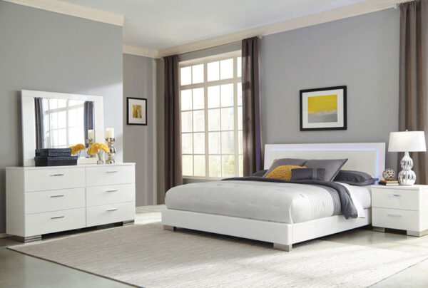 Modern bedroom with white furniture and gray accents.