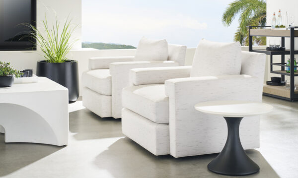 Modern white chairs on a sunny patio