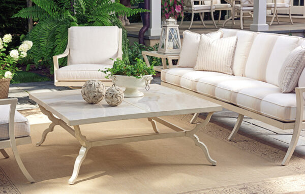 Elegant patio furniture set with table and chairs.